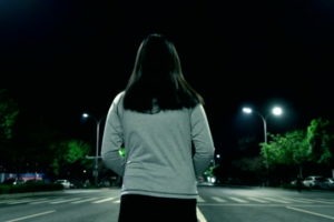 Woman walking alone at night street